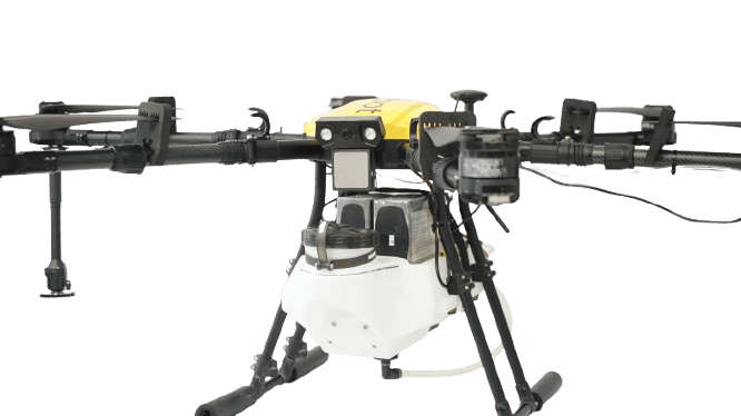 A drone pilot operating an agricultural spraying drone over a field